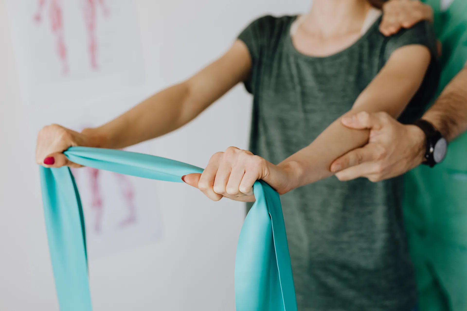 A physical therapist supporting a patient during a resistance-band exercise